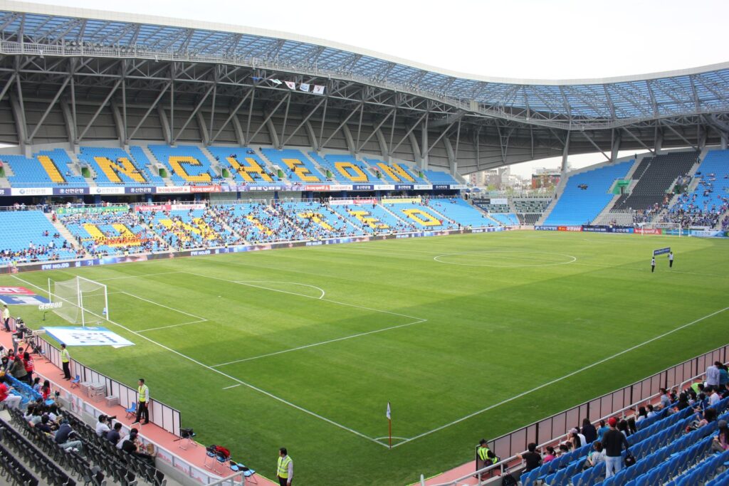 Empty soccer stadium seats and pitch